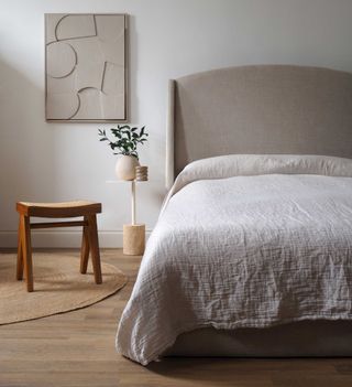 a bed styled with a minimalist coverlet