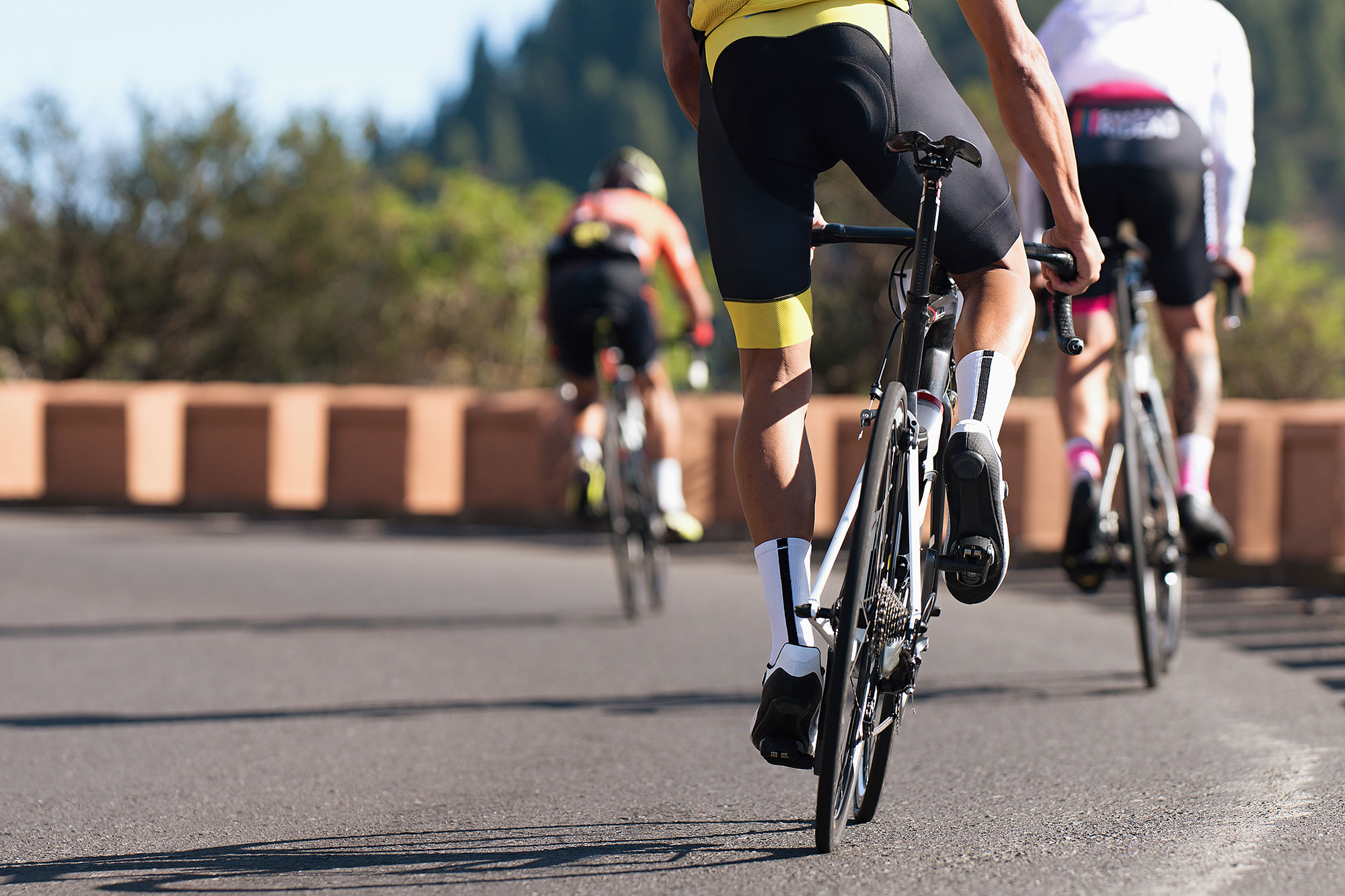 Riders descending left-hand bend
