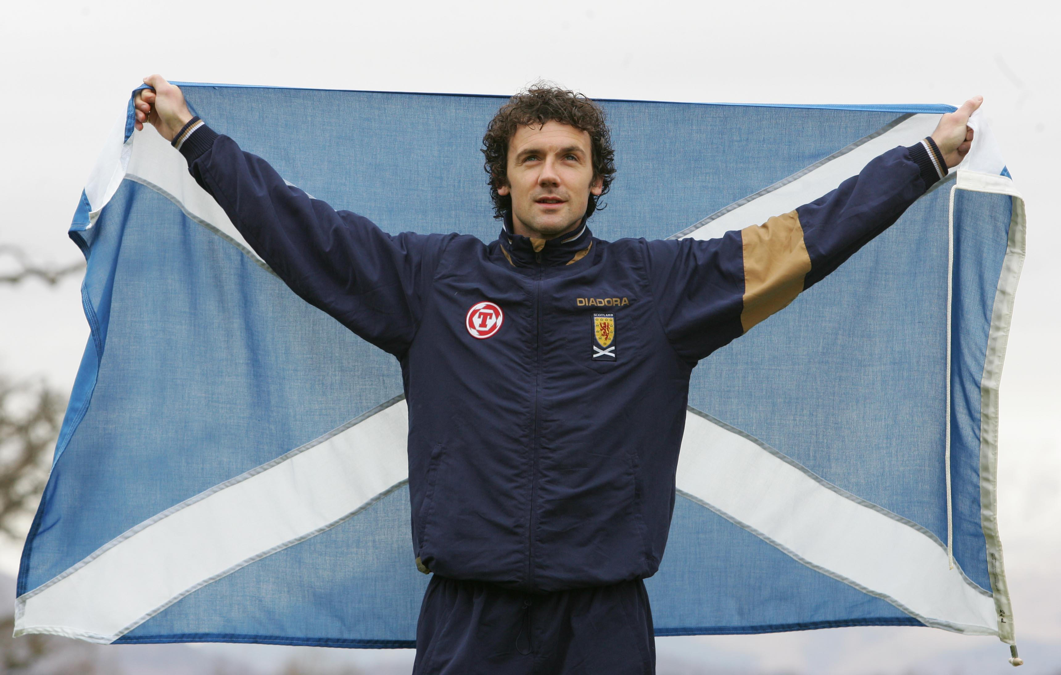 Scotland defender Christian Dailly poses with a Scottish flag, 2007