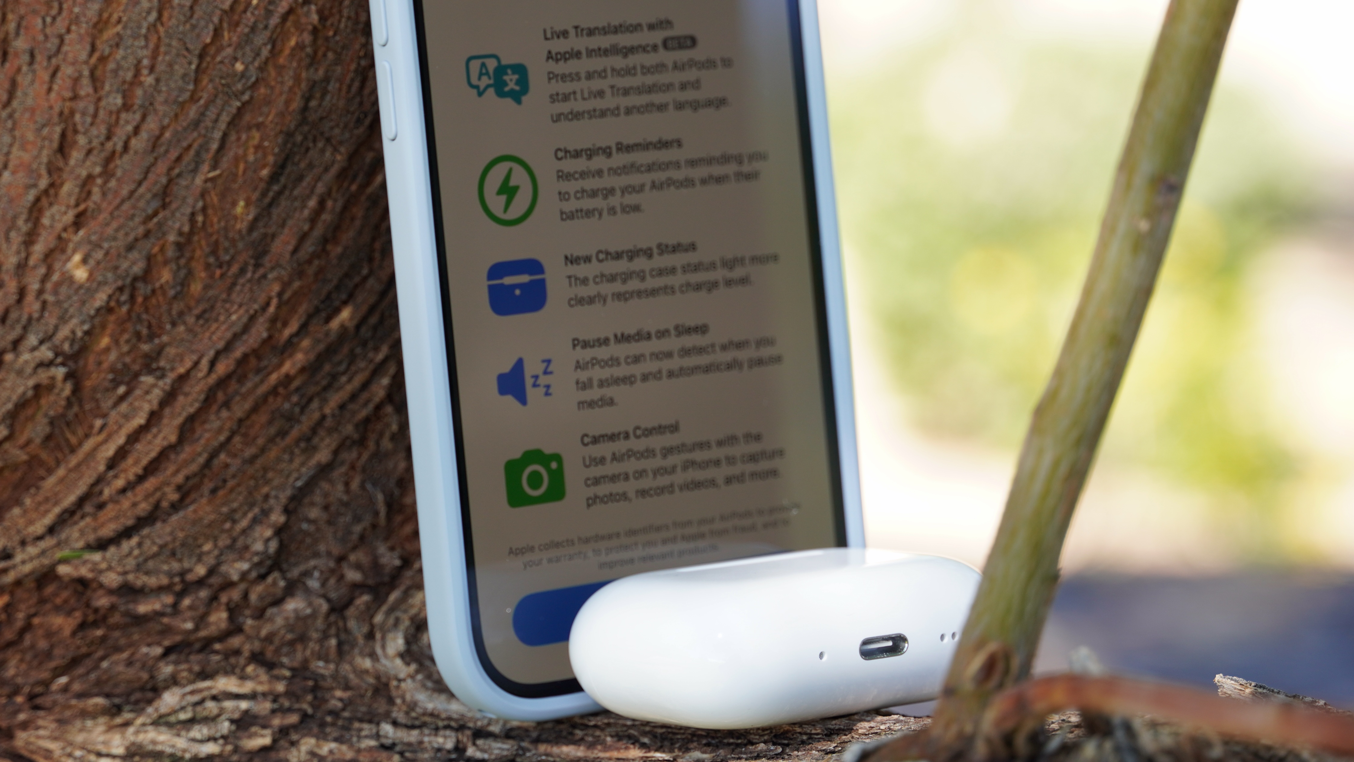 The AirPods Pro 3 with their charging case at a park. 