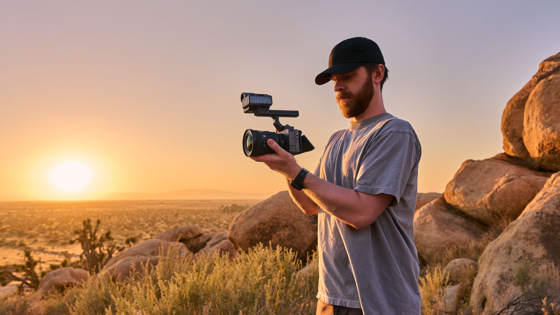 Sony FX5 with top handle attached, held by video shooter in an arid outdoor landscape at golden hour