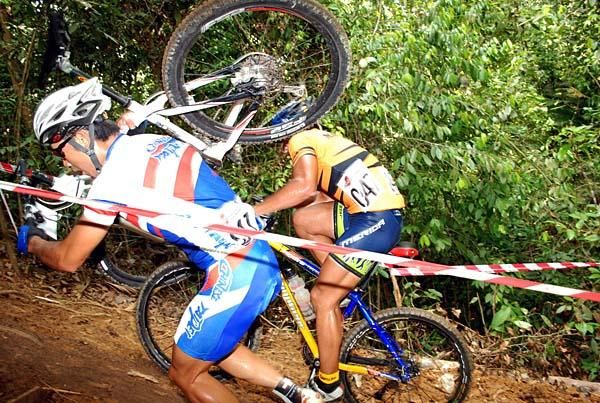 Two racers take different strategies on this climb. One runs, one rides.