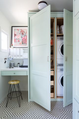 A hidden laundry cabinet next to a work station
