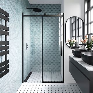 blue tiled shower room with black enclosure and vanity unit