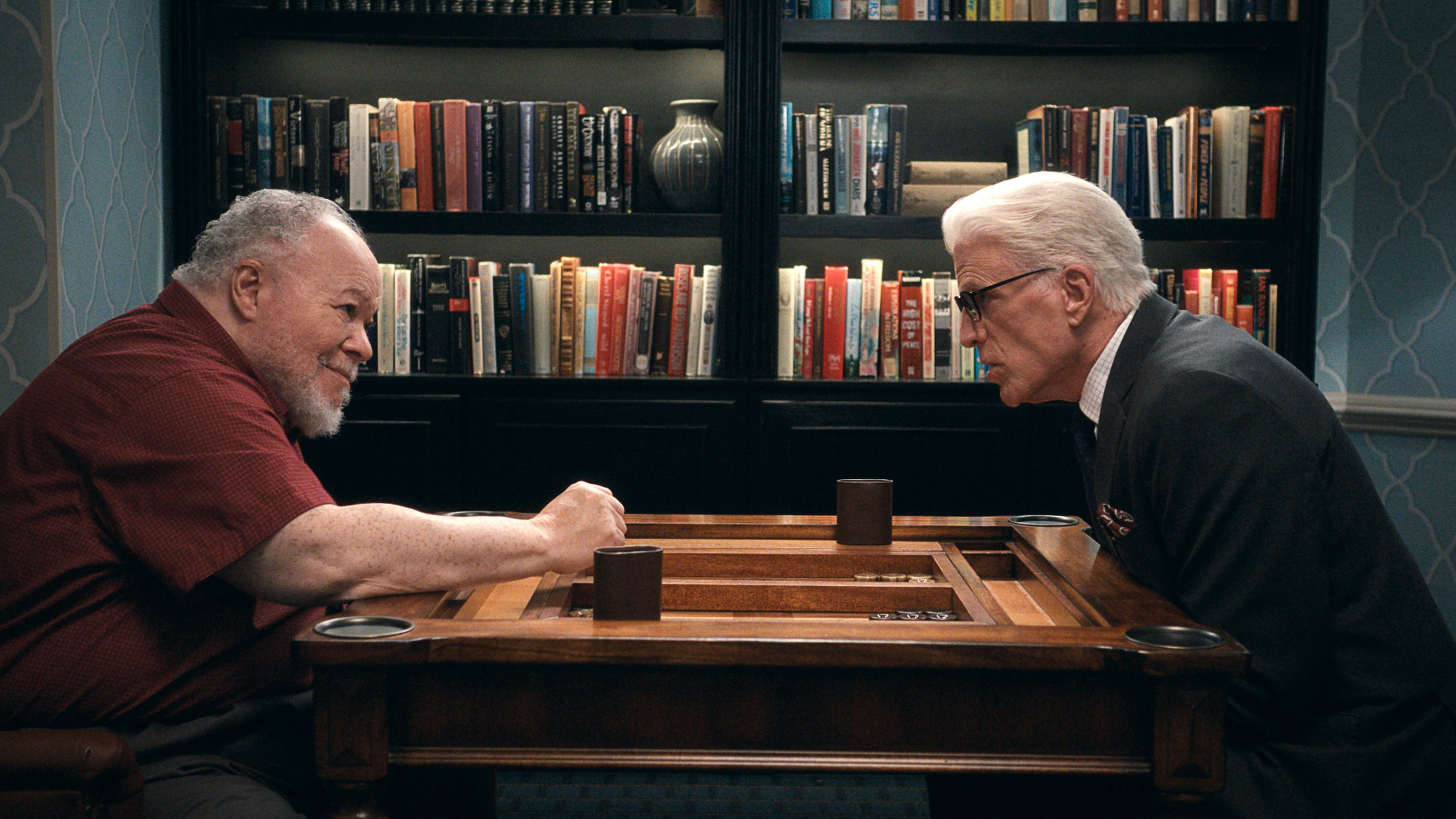 L-R: Calbert (Stephen McKinley Henderson) and Charles (Ted Danson) play a board game in a scene from "A Man on the Inside" season 2