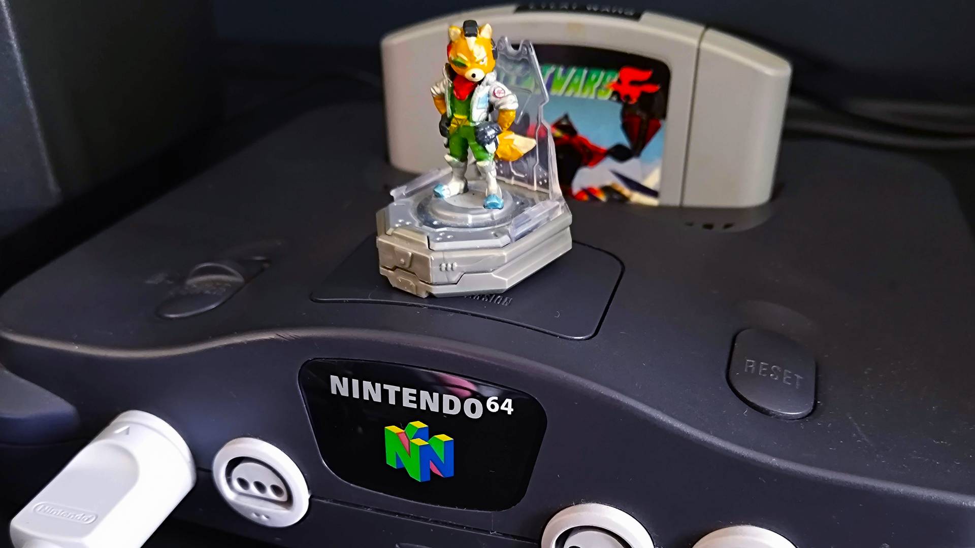 Close up of N64 with Fox McCloud figure on top.
