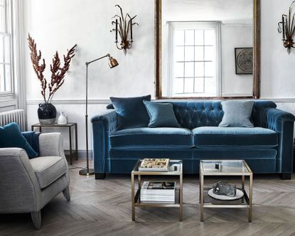 living room with blue velvet sofa