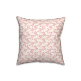 A white and pink skull throw pillow