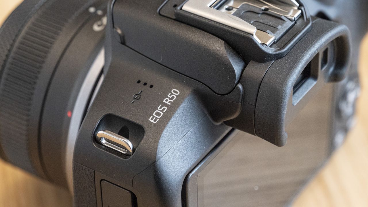 Top of Canon EOS R50 on a table close up of model name
