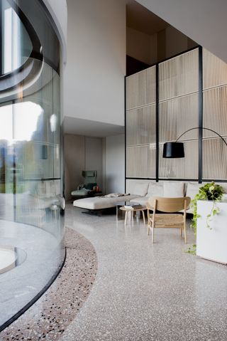 A living room with curved glass