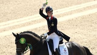 Gold medalist, Charlotte Dujardin of Great Britain riding Valegro celebrates during the medal ceremony at Rio 2016