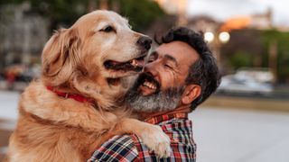 man hugging his dog