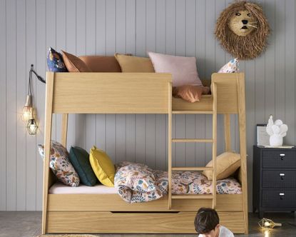 La Redoute Alceste Oak Bunk Bed in kids room, with colourful cushions and grey panelled wall