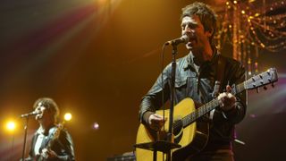 Noel Gallagher (R) and Russell Pritchard of Noel Gallagher's High Flying Birds perform during KROQ's Almost Acoustic Christmas 2011 at Gibson Amphitheatre on December 11, 2011 in Universal City, California