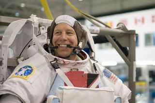 NASA astronaut Tim Kopra, attired in a training version of his Extravehicular Mobility Unit (EMU) spacewalking spacesuit