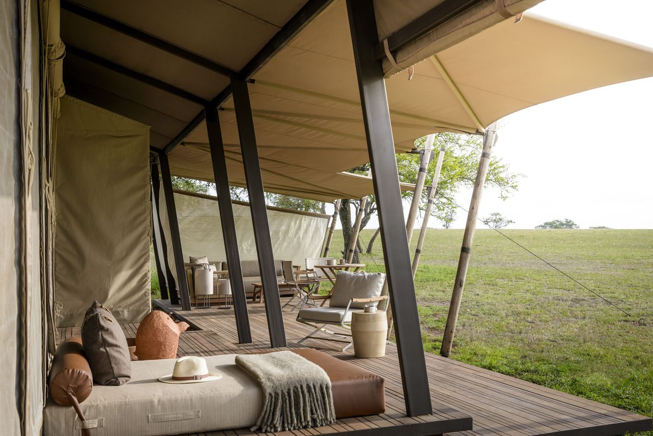 The canopied deck of a luxurious safari tent