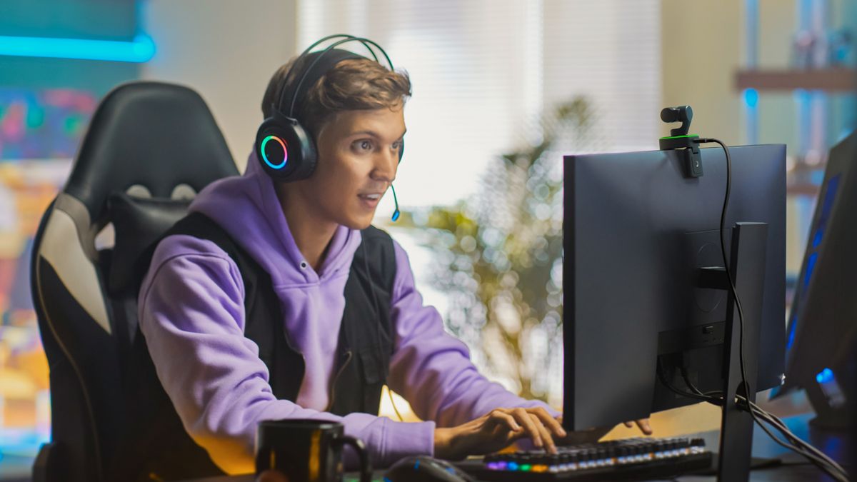 A gamer streaming in front of the Insta360 Link webcam
