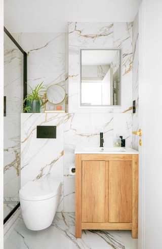 Small marble bathroom with walk in shower