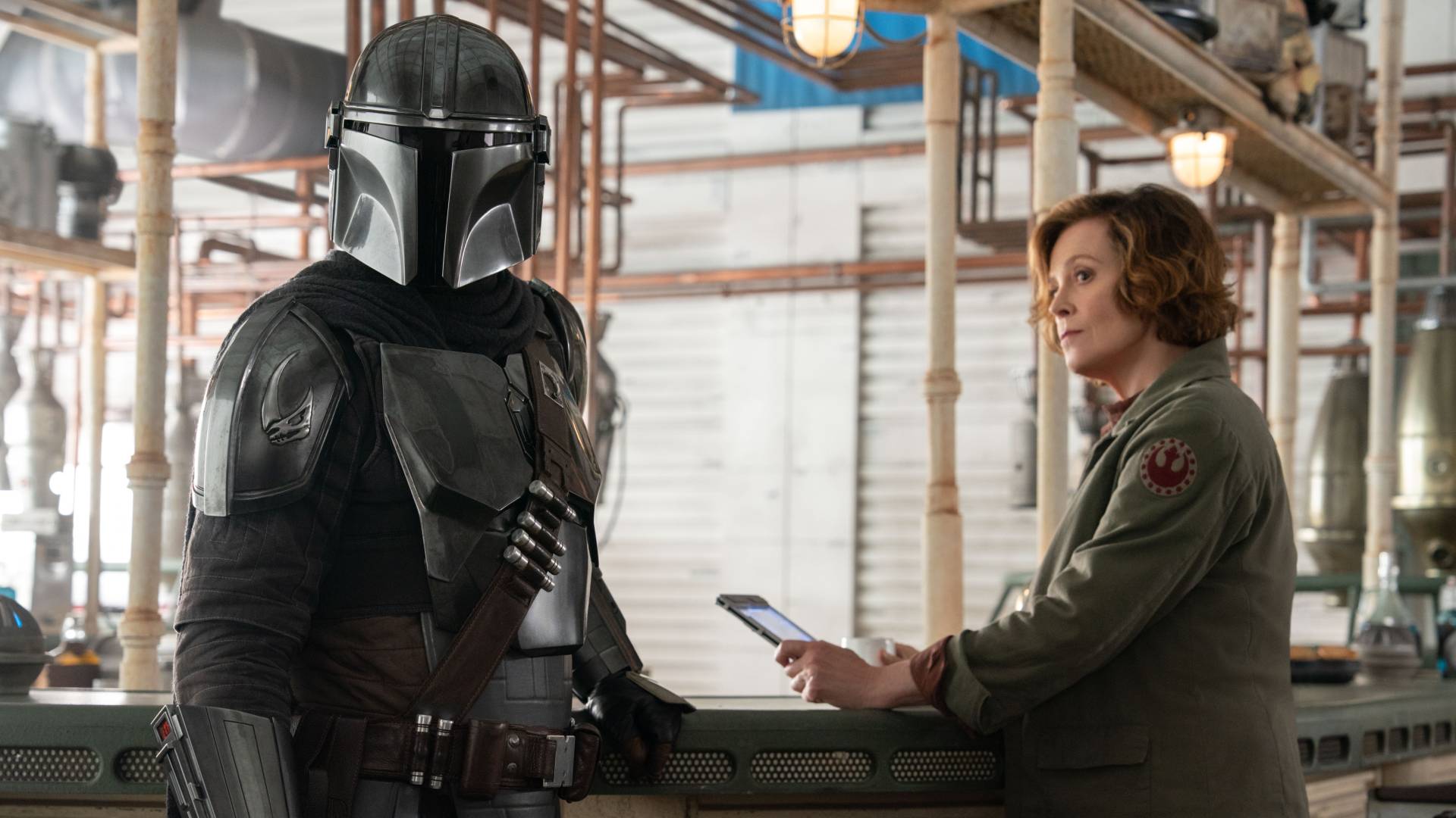Pedro Pascal as Din Djarin and Sigourney Weaver as Colonel Ward in The Mandalorian and Grogu 