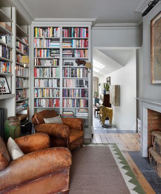 Reading room with floor to ceiling bookshelves and leather brown armchairs