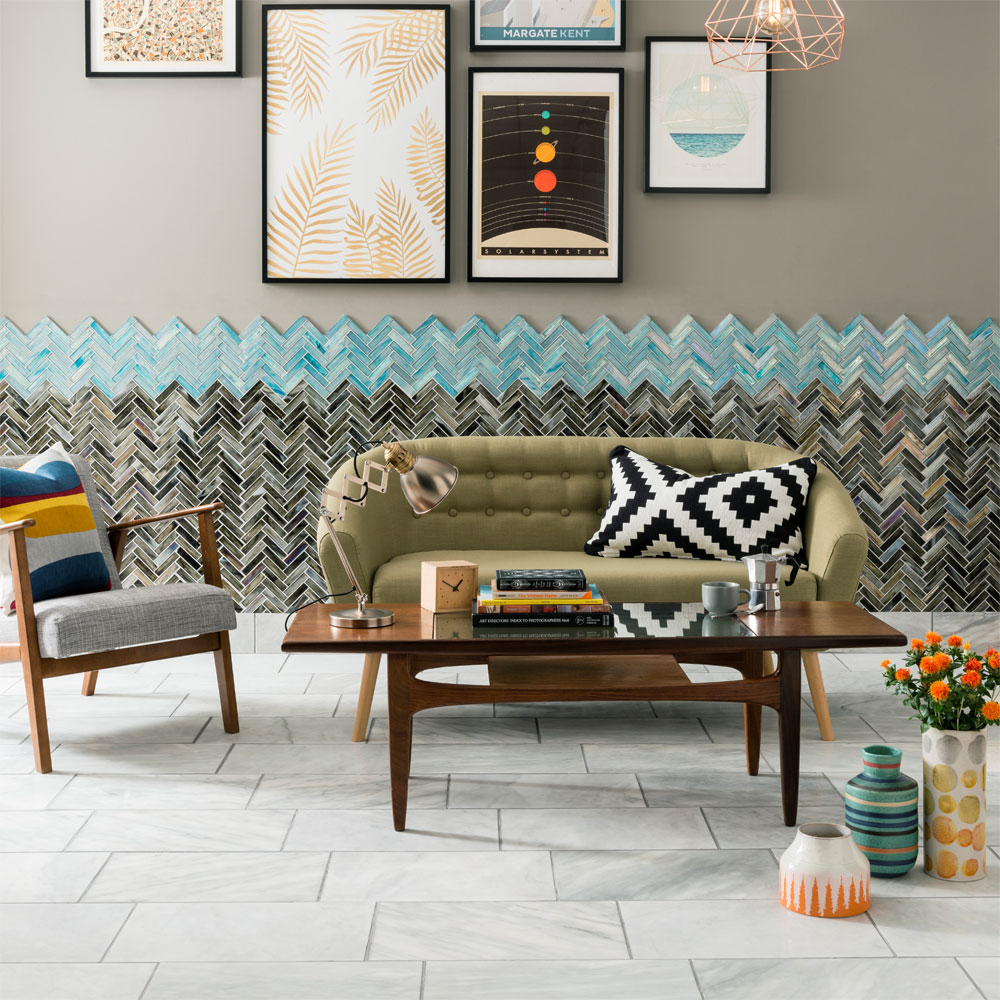 living room with grey wall and green sofa