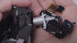 DualShock 4 trigger mechanism next to PS5 DualSense adaptive trigger mechanism