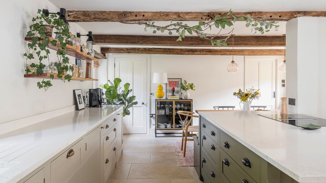 kitchen with cream cabinetry and green island looking down to table, chairs and drinks cabinet