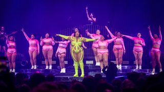 Lizzo dancing on stage with her back-up dancers