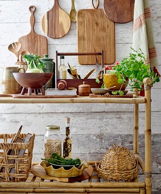 Bamboo console table with artisanal wooden boards, glass storage jars and reactive glaze-ware canisters