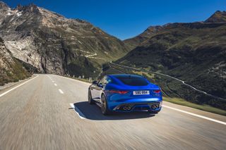 Driving blue Jaguar F-Type through mountains