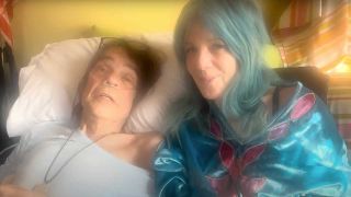 David Johansen in his hospital bed, wife Mara sitting bedside 