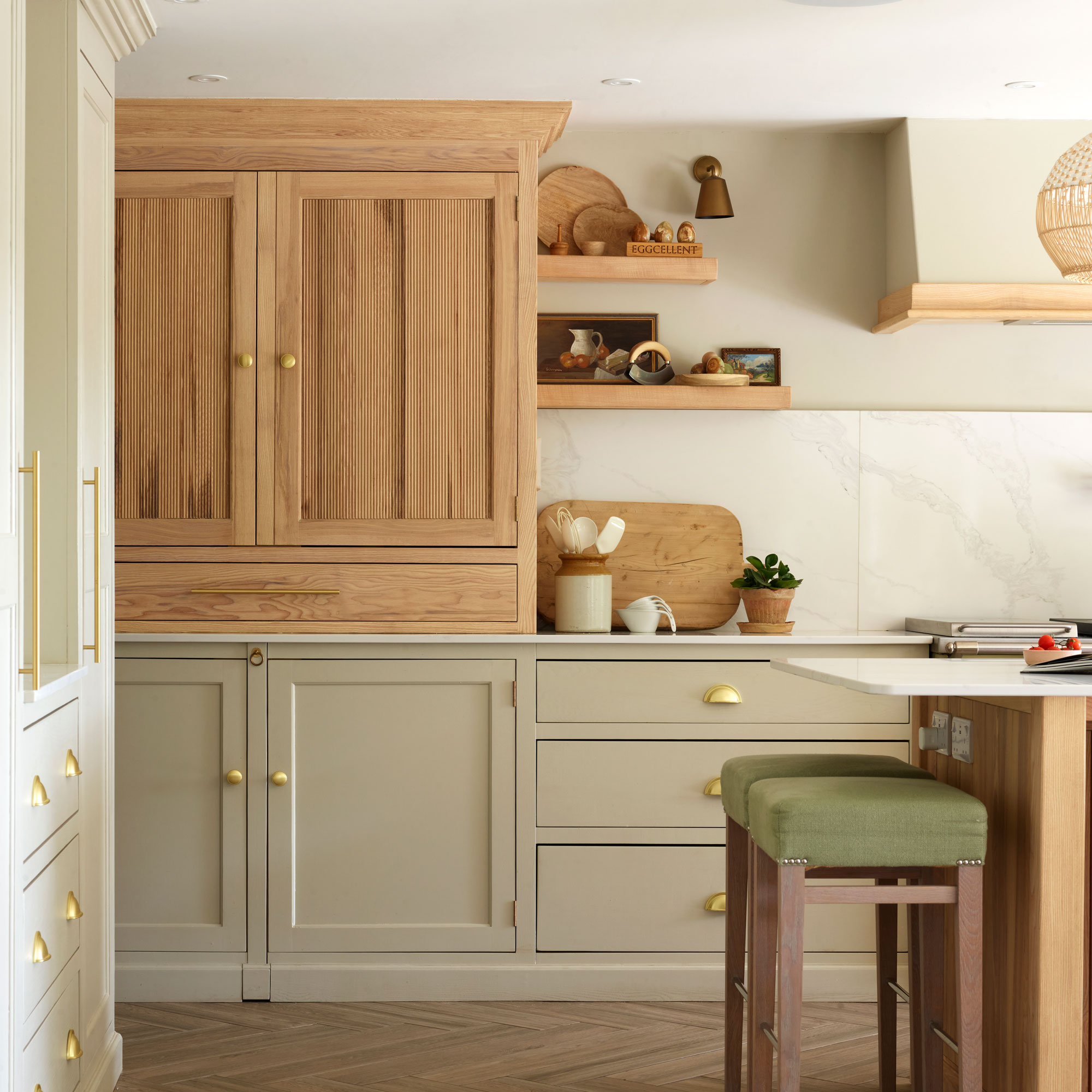Green kitchen with wooden cabinet and stools
