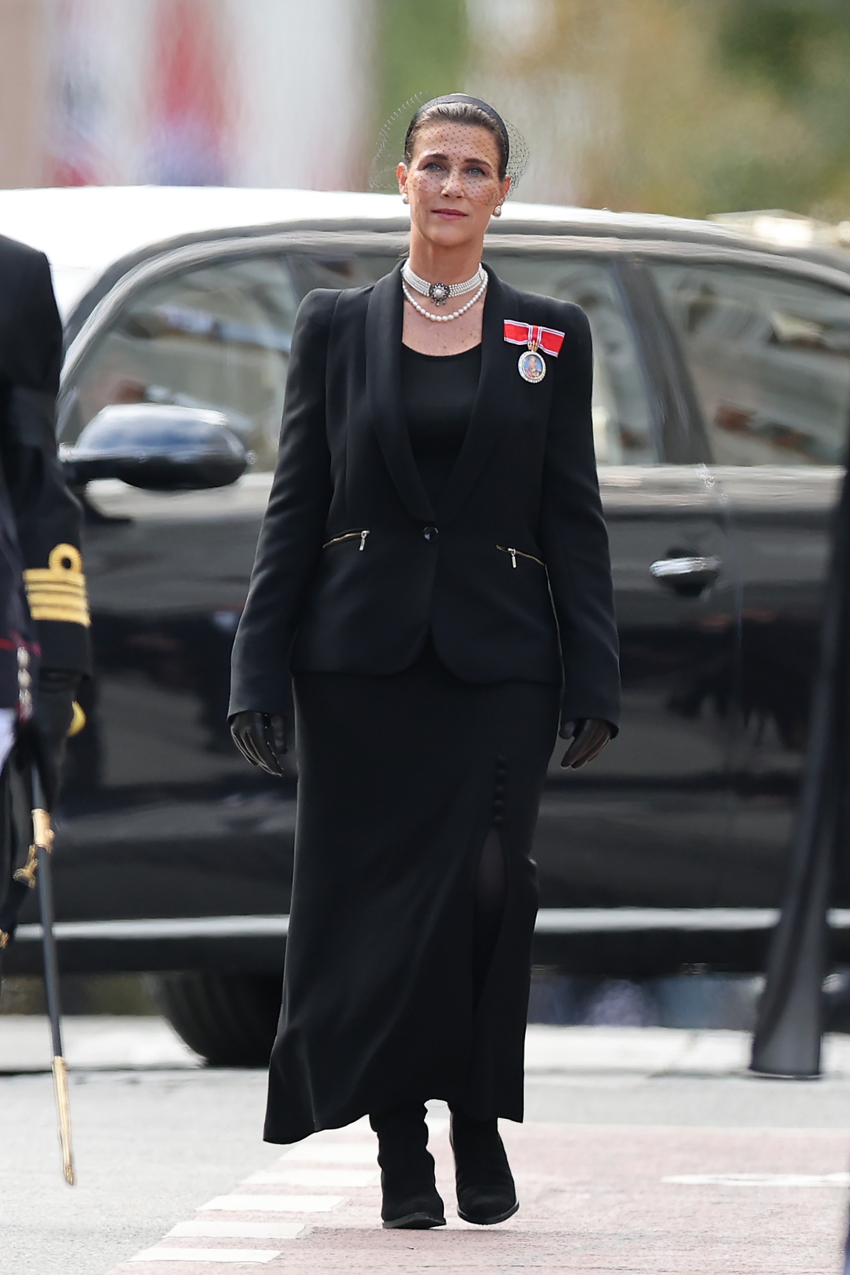 Princess Martha Louise wearing black walking at King Harald's funeral