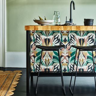 patterned kitchen island in green kitchen with rug