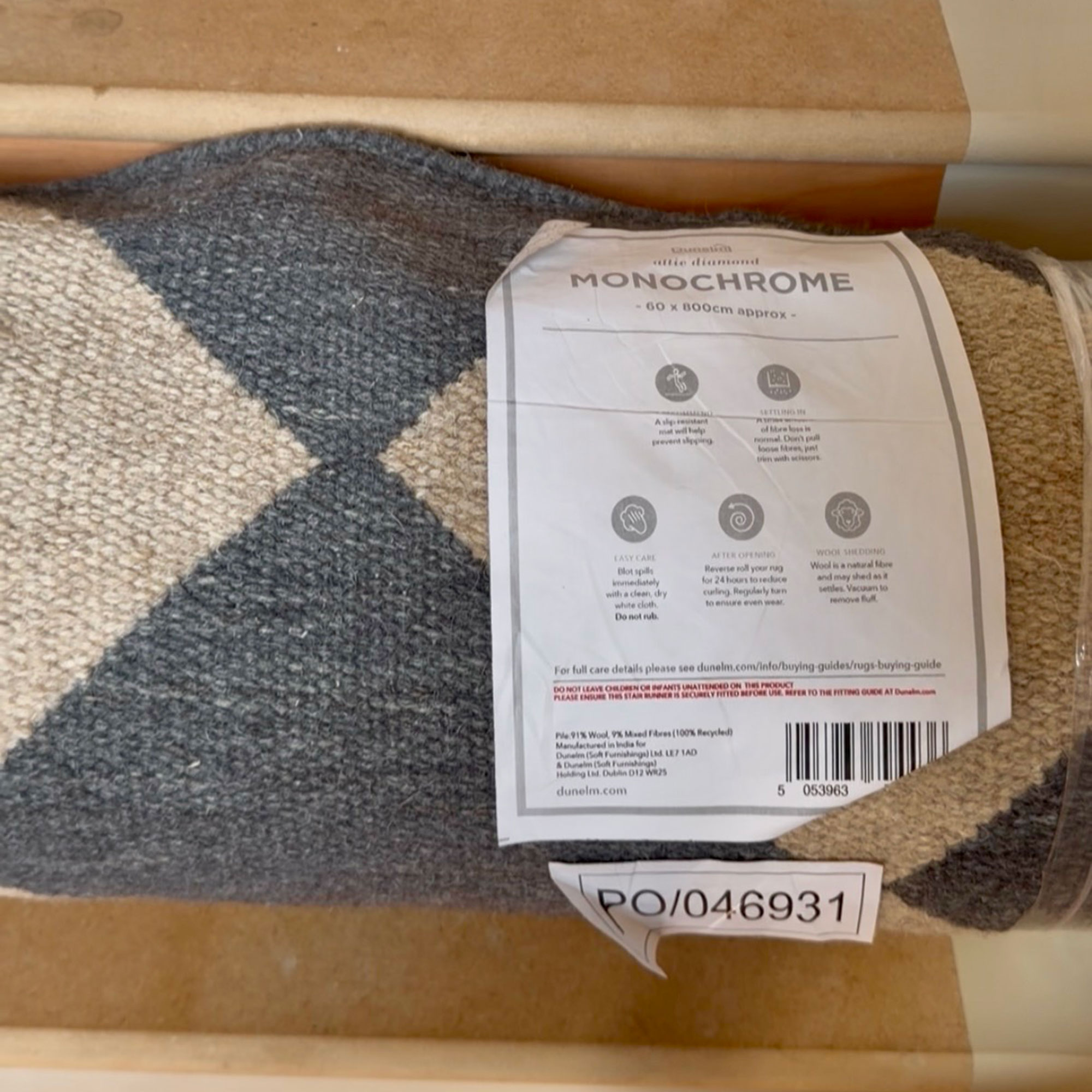 Rolled up rug with shop label on it