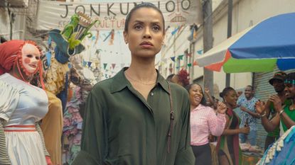Gugu Mbatha-Raw stands in the middle of a street carnival
