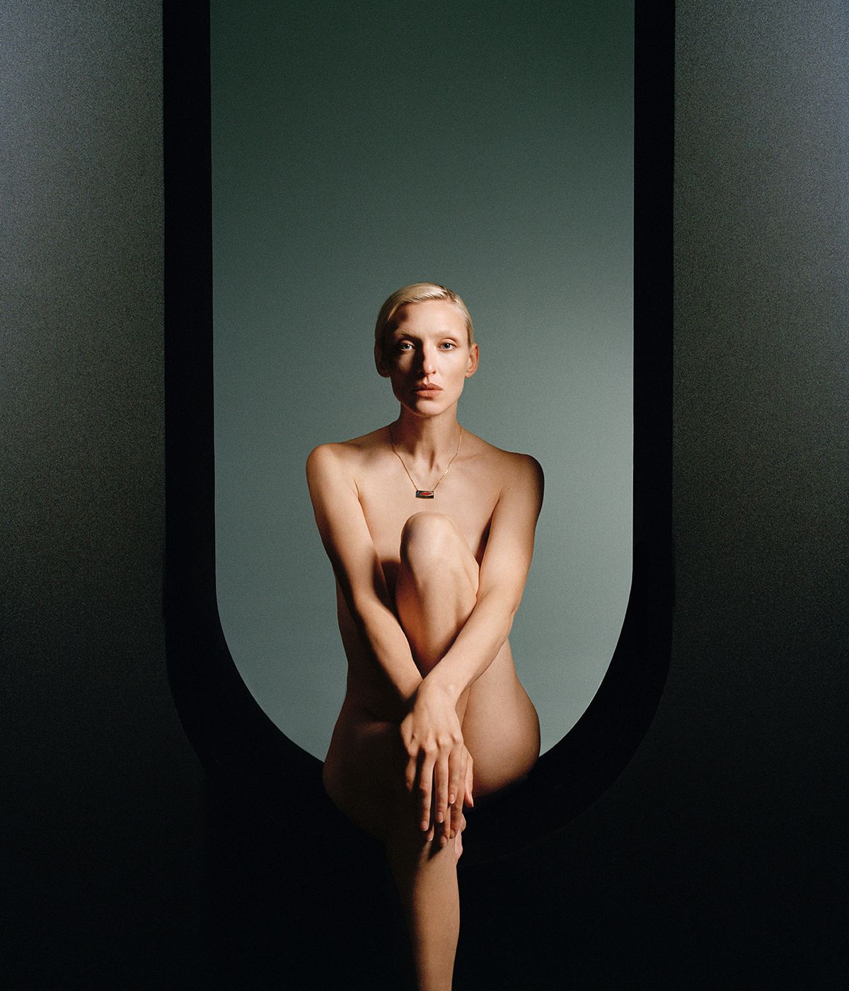 nude woman wearing necklace