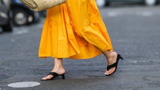 woman wearing black heeled thong sandals