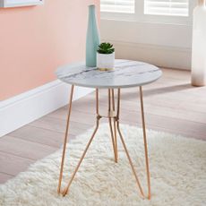 peach wall with wooden flooring bottle and table