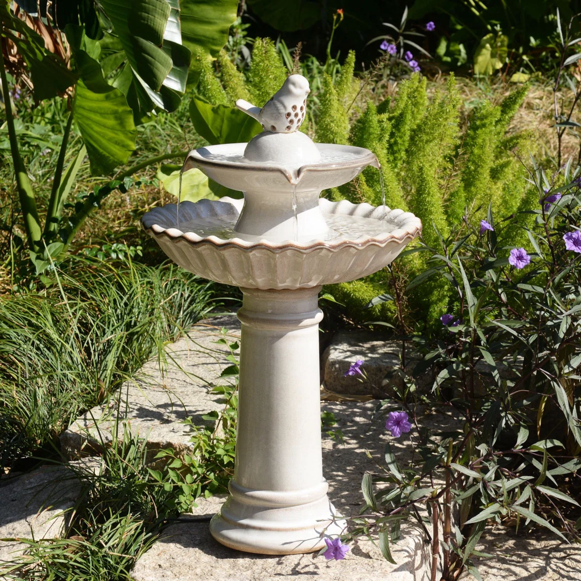 Scalloped concrete bird bath with fountain