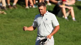 Bryson DeChambeau fist pumps after holing a chip