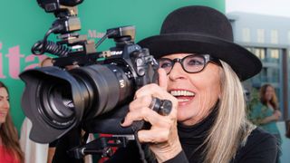Diane Keaton holds the camera of a media photographer as she arrives at the premiere of "Mack & Rita" on Wednesday, Aug. 10, 2022, at NeueHouse Hollywood in Los Angeles. (Photo by Willy Sanjuan/Invision/AP) - Image ID: 2MAX6GJ