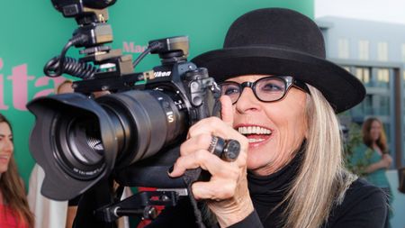 Diane Keaton holds the camera of a media photographer as she arrives at the premiere of "Mack & Rita" on Wednesday, Aug. 10, 2022, at NeueHouse Hollywood in Los Angeles. (Photo by Willy Sanjuan/Invision/AP) - Image ID: 2MAX6GJ