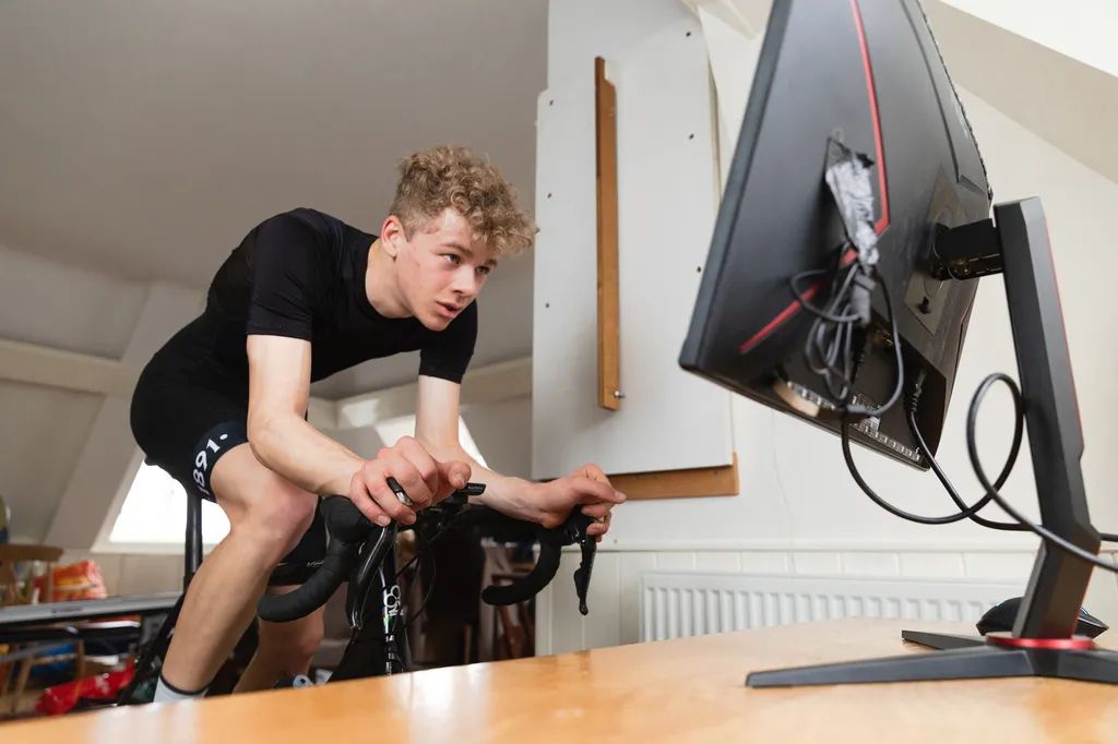A young male cyclist on an indoor bike