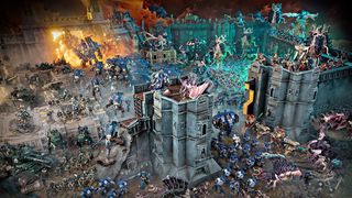 A huge battle between Space Marine and Tyranid miniatures.
