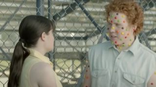 A boy is infected with Skittles Pox and has Skittles all over his face.