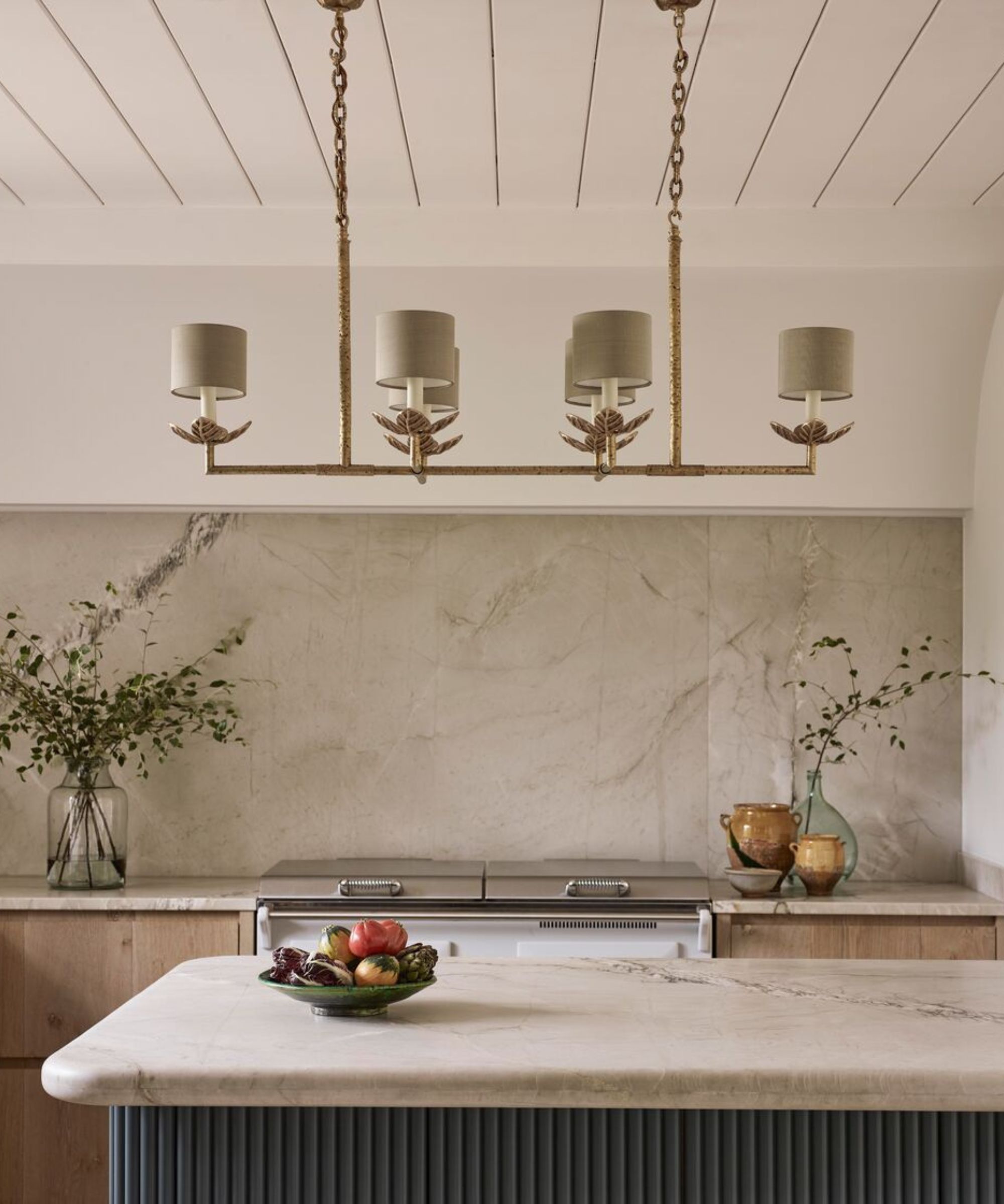 a warm neutral kitchen with a decorative chandelier