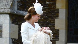 Kate Middleton holds Princess Charlotte at her Christening