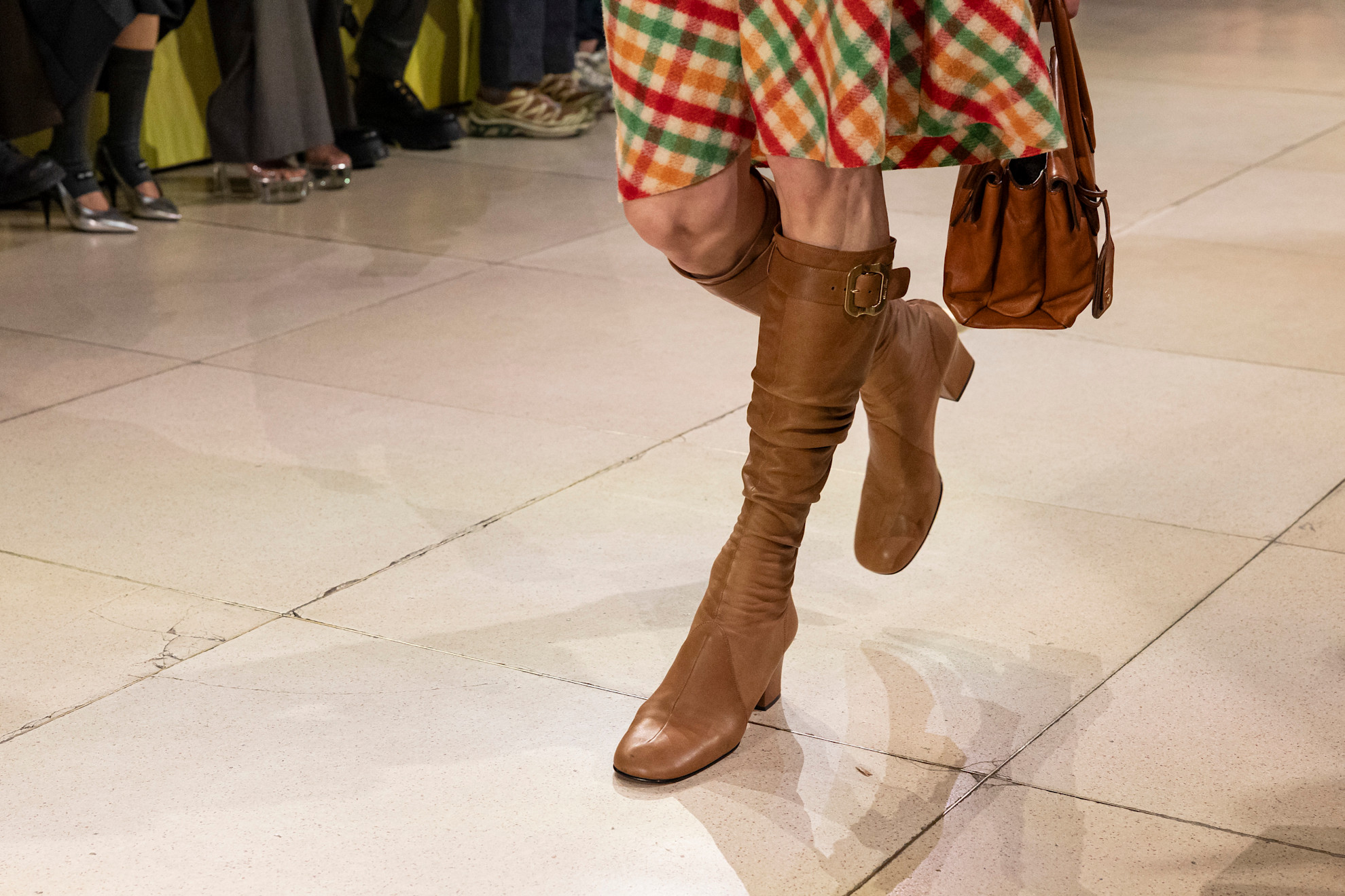 An image of the Miu Miu Autumn/winter 2025 runway. The model wears one of winter shoe colour trends 2025, peanut butter.