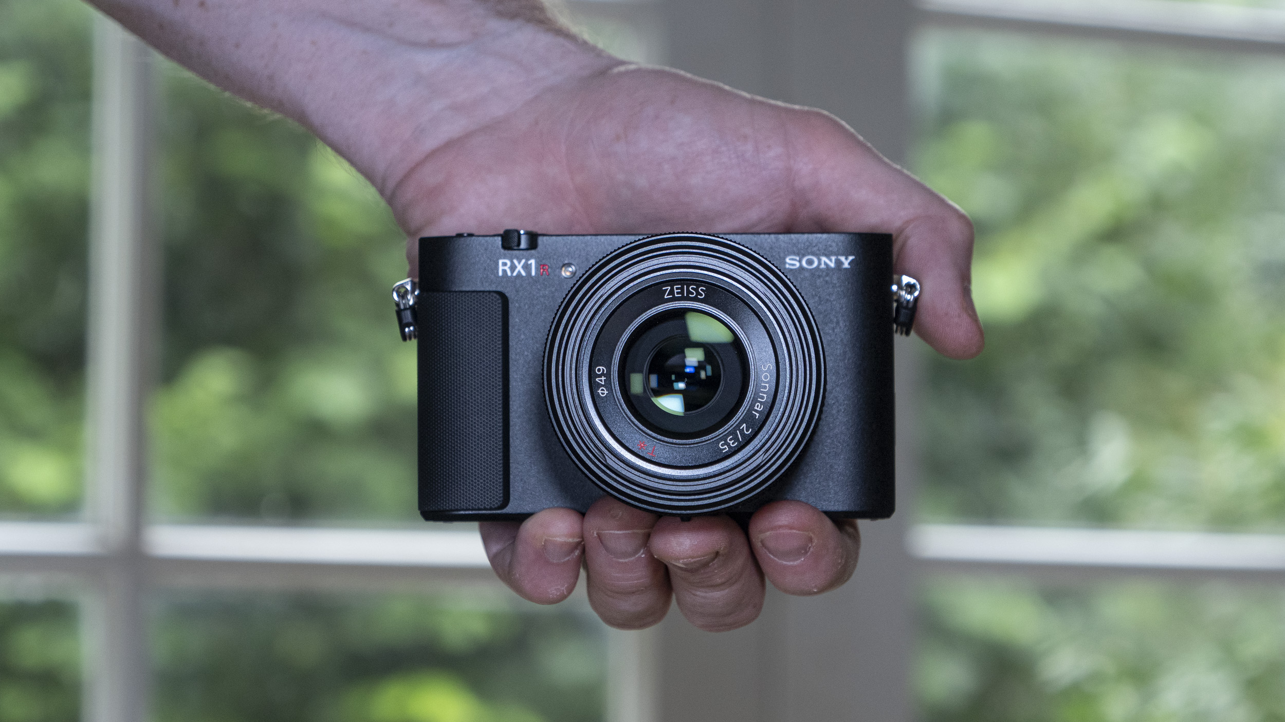 Hand holding the Sony RX1R III compact camera